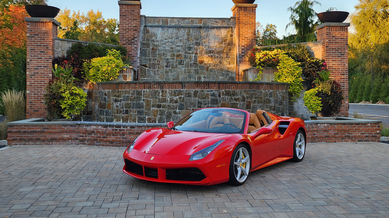 Image of a 2017 Ferrari 488 Spider in front of a brick structure.