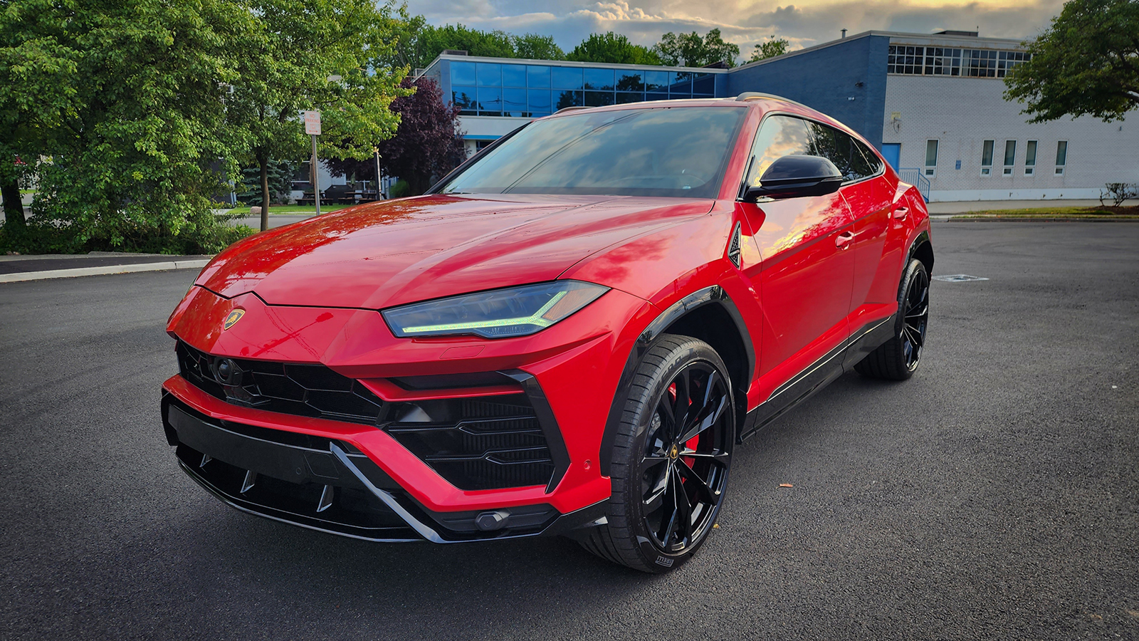 Image of a Lamborghini Urus parked in front of a building